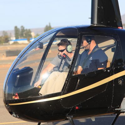 Helicopter pilot and student inside a Robinson R22 Beta II helicopter