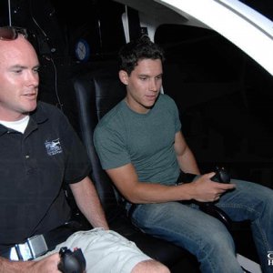Student and instructor fly in a helicopter flight simulator.